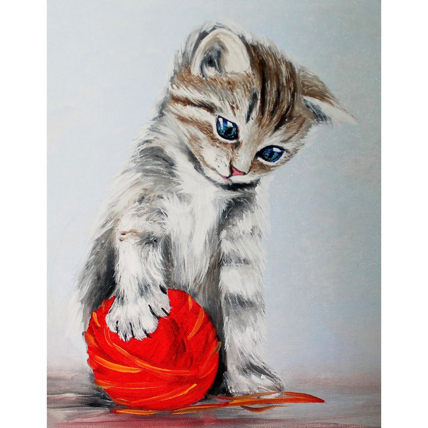 Kitten with a red clew