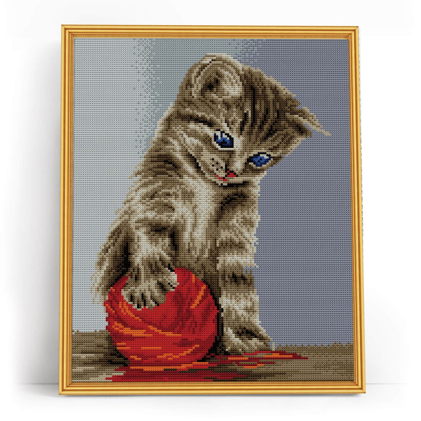 Kitten with a red clew